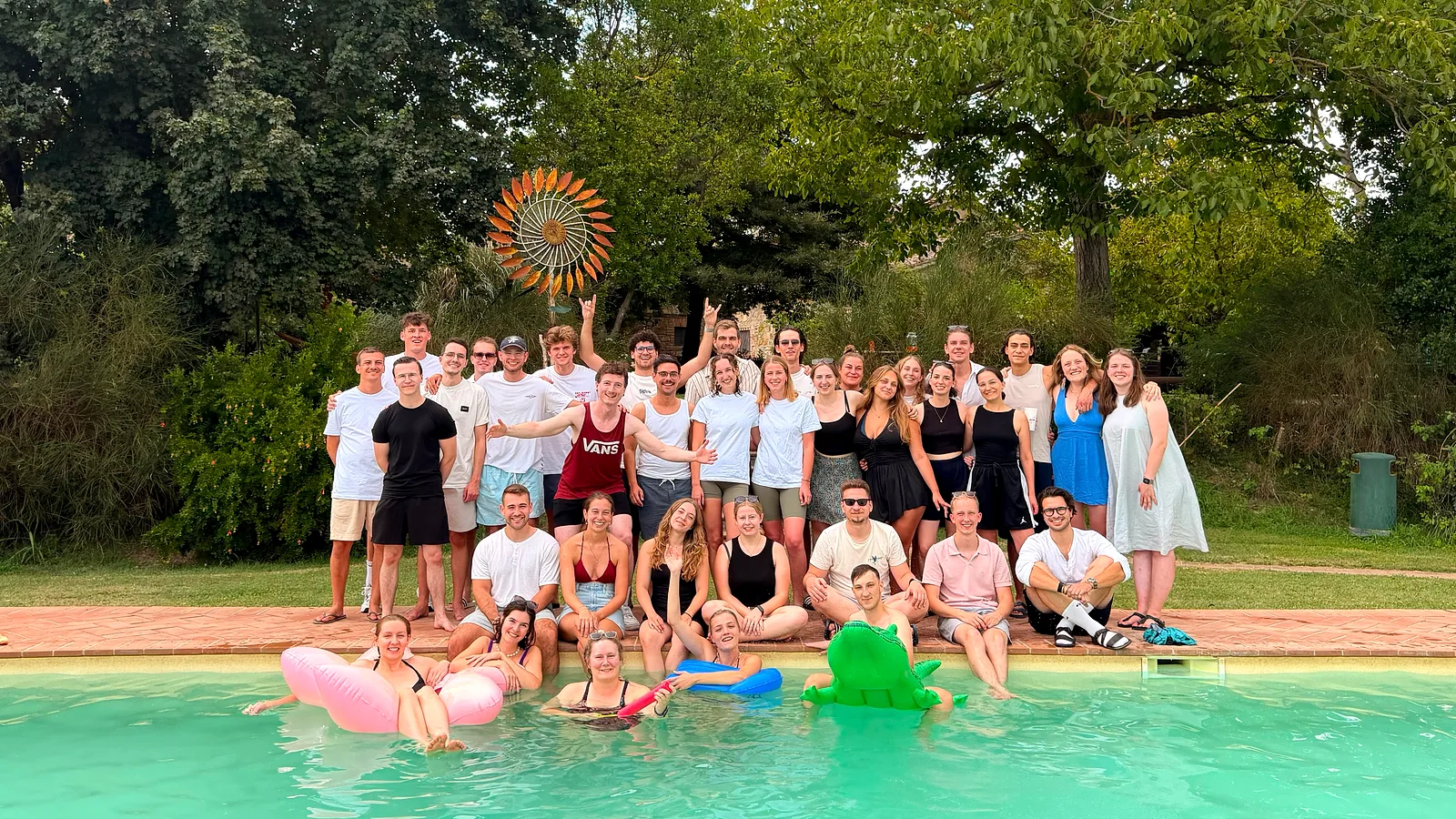 Gruppo di ospiti in posa a bordo piscina al Borgo Santa Maria